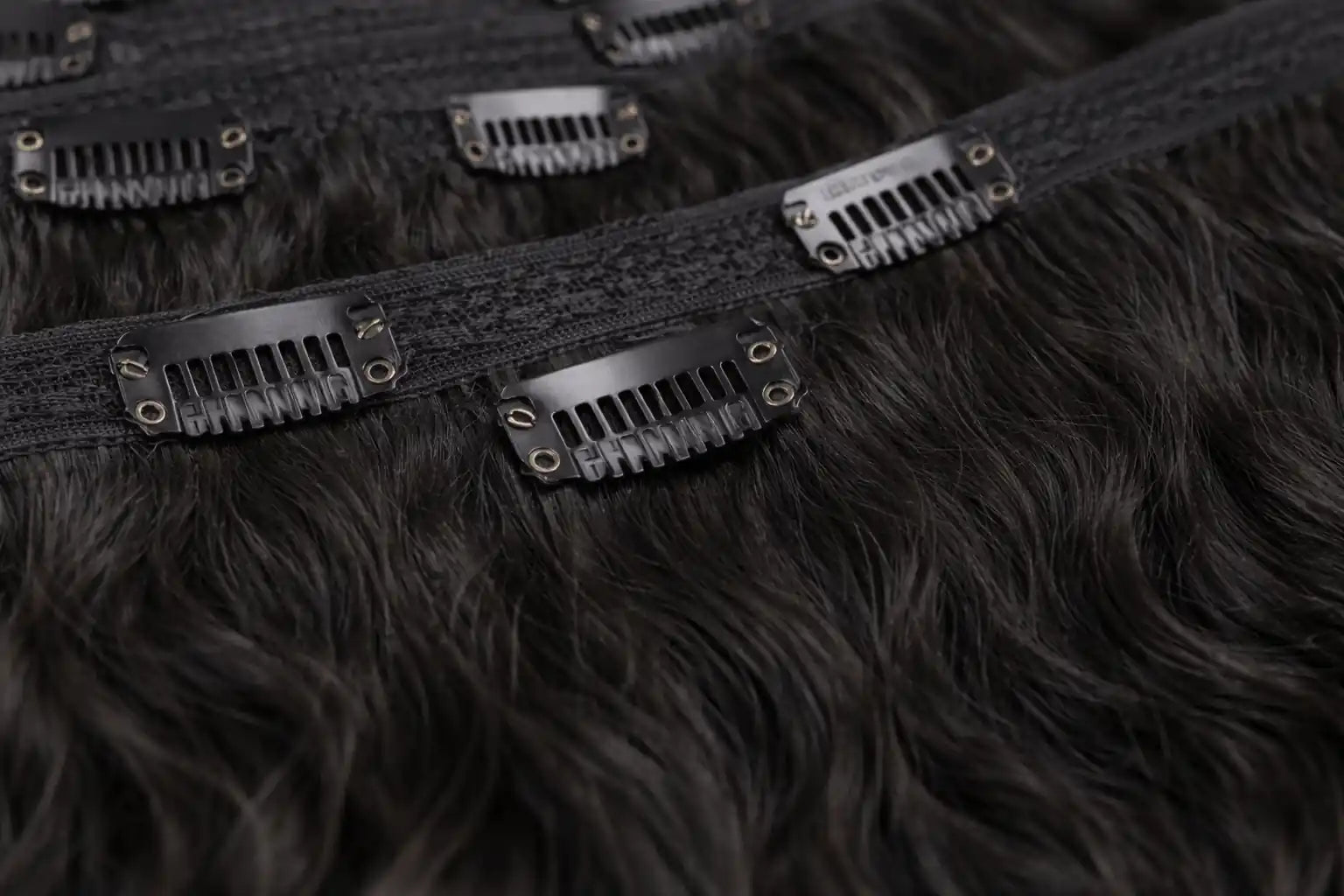 Wholesale Curly Raw Indian Hair Sets: Multiple sets of curly raw Indian hair clip-ins, ideal for stylists and salon owners looking for factory-direct quality.