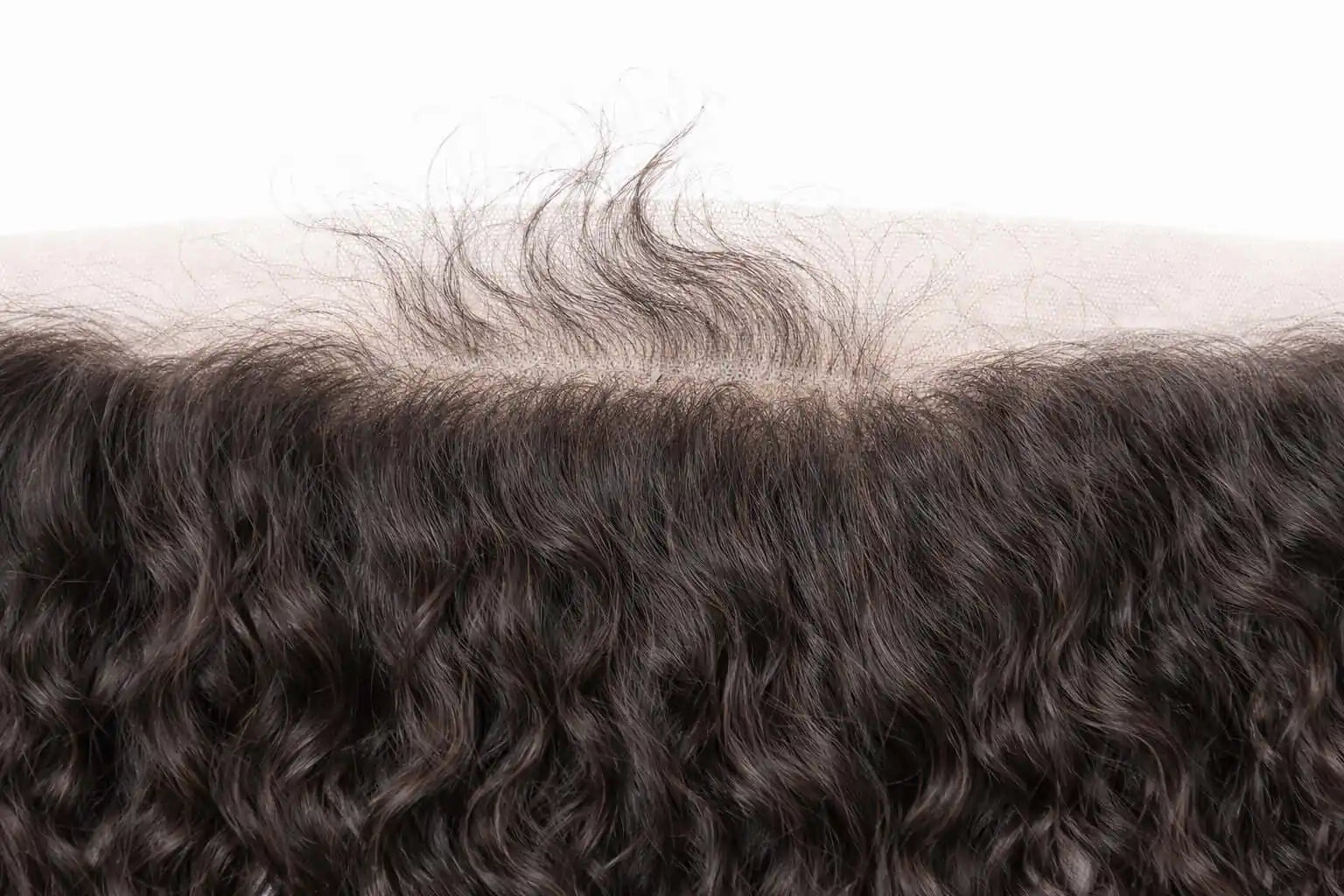 Close-up of high-definition (HD) transparent lace on a curly raw Indian hair frontal, demonstrating the ultra-thin material designed for undetectable "scalp-like" blending.