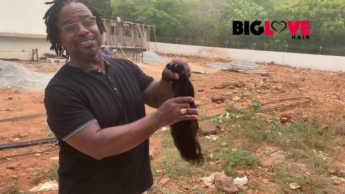 Wholesale buyer reviewing the quality of BigLove raw Indian hair bundles