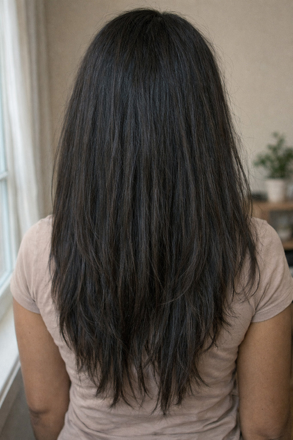 A model in a high-fashion pose wearing a full install of Straight Raw Indian Hair Bundles, emphasizing the luxury volume and authentic natural black color.
