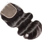 Macro view of a raw Indian hair closure sample showing hand-tied single knots for a realistic, non-bulky scalp appearance.
