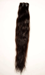 Raw Indian hair sample held under natural light to showcase the authentic, healthy luster of unprocessed temple hair.