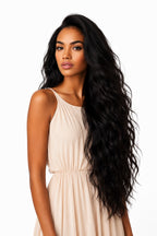 Model wearing a full install of premium raw Indian wavy hair extensions from BigLove, showcasing an effortless, high-volume beach wave style.