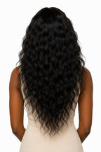 rear view of a loose curly textured raw Indian hair install, showcasing the 24 inches length of natural curly hair extensions against a models back .