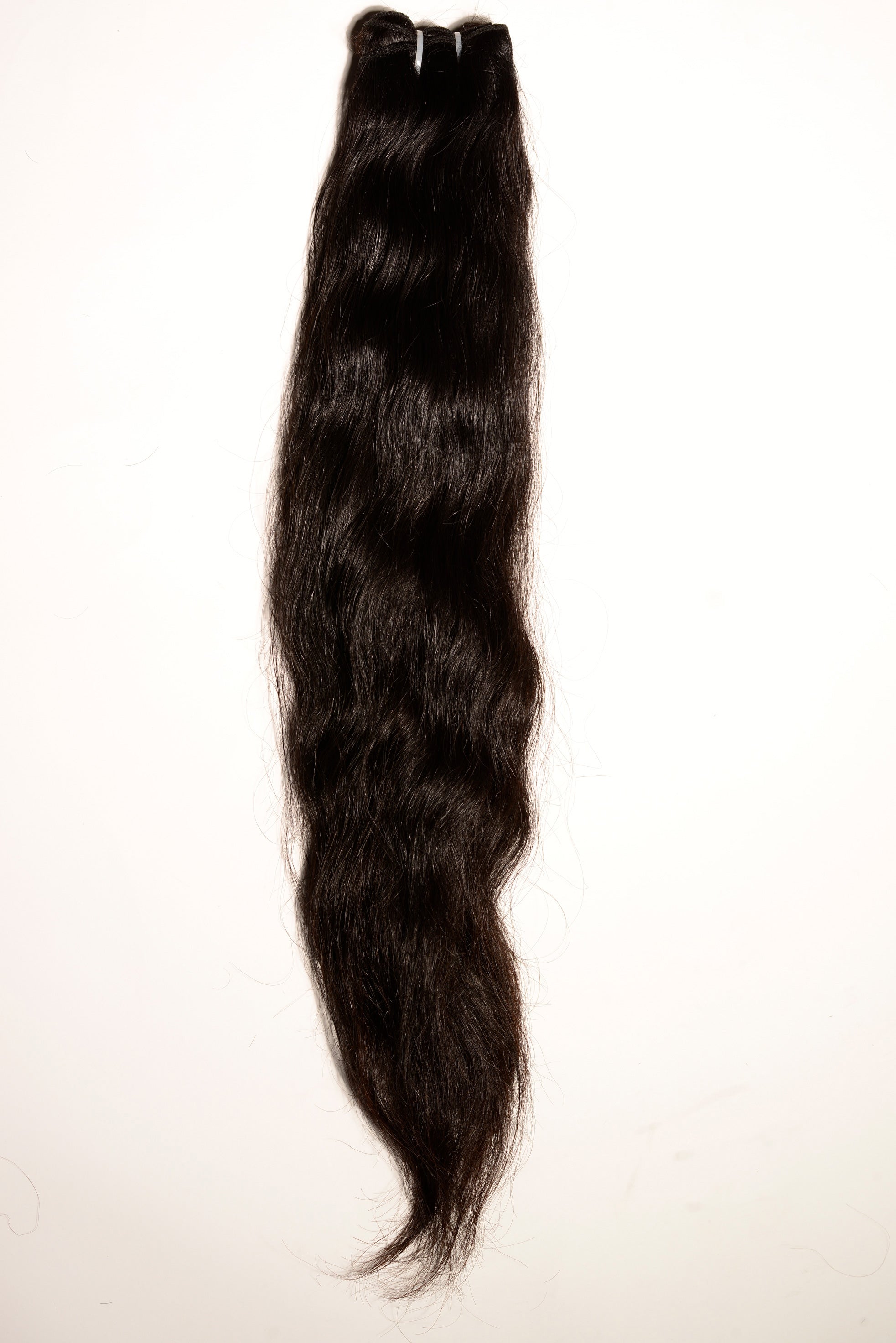 Straight Raw Indian Hair Bundles in Natural Black, showcasing the sleek, unprocessed texture and uniform density from top to bottom. The hair is wefted and the bundles weigh 100 grams